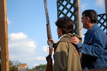 boy holding shotgun